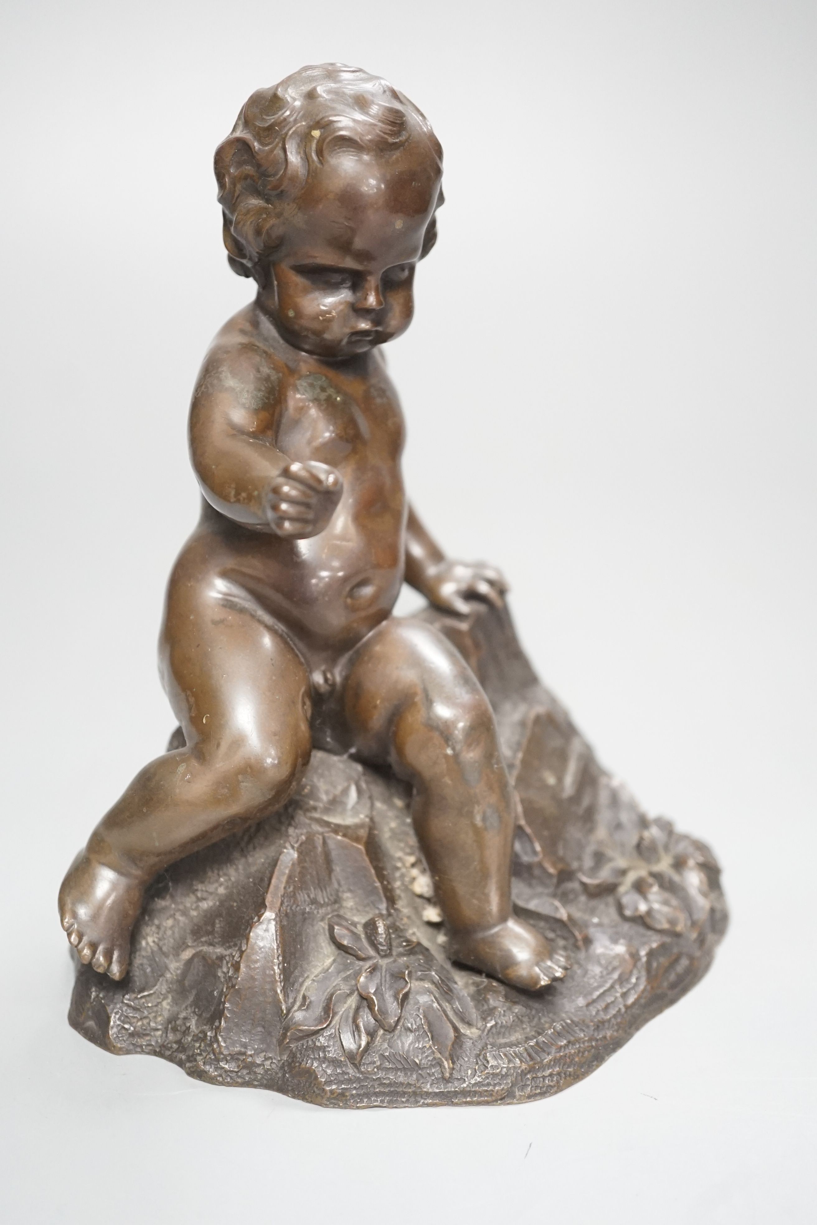 A bronze of a seated boy, height 17cm